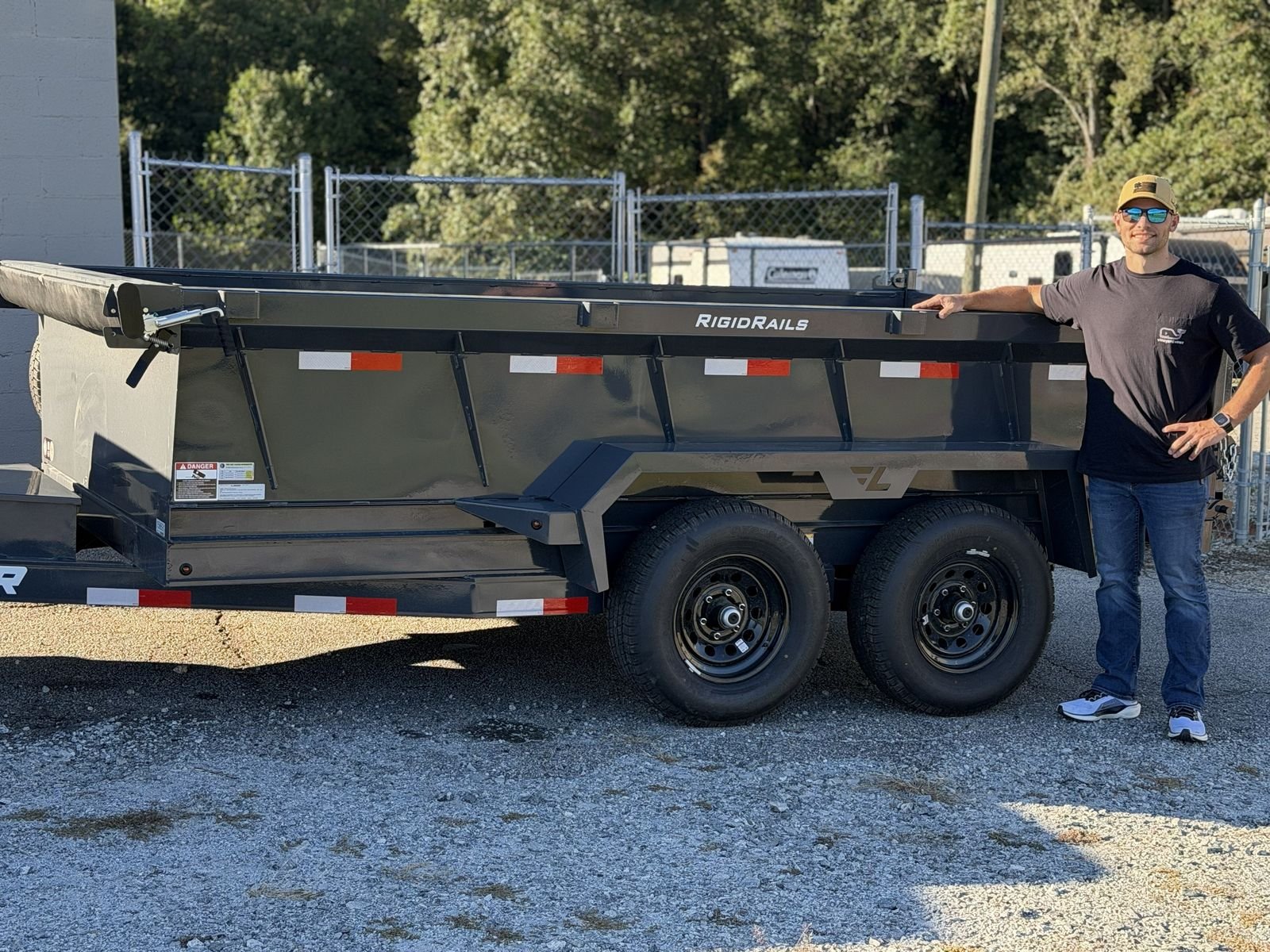The owner of Apex Trailer Solutions standing beside the company's first Lamar dump trailer